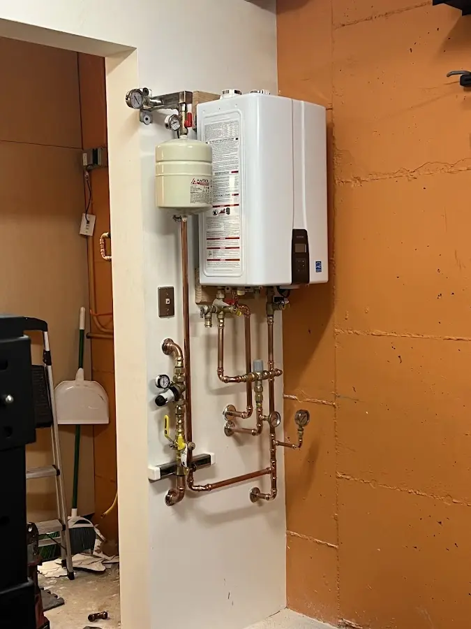 Plumbing technician inspecting water heater connections in Buckhead